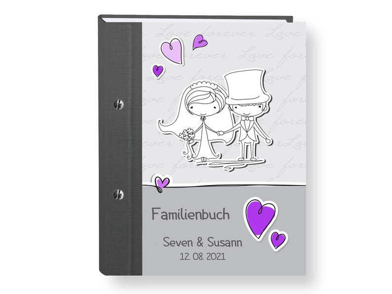 May include: A gray photo album with a black spine and a cover featuring a cartoon bride and groom with purple hearts. The text on the cover reads "Familienbuch" "Seven & Susan" "12.08.2021".