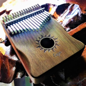 Beautiful Sounding & playing 17 key Kalimba-Special. 2 colors available. See pictures These are in stock now. Will ship right away.