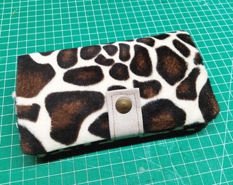 Giraffe tobacco pouch made of imitation fur with zippered pocket for filters, optional rubber or snap fastener closure.