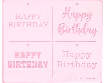 May include: Pink plastic stencil with four different "Happy Birthday" designs. The stencil has two designs with a block font and two designs with a cursive font.