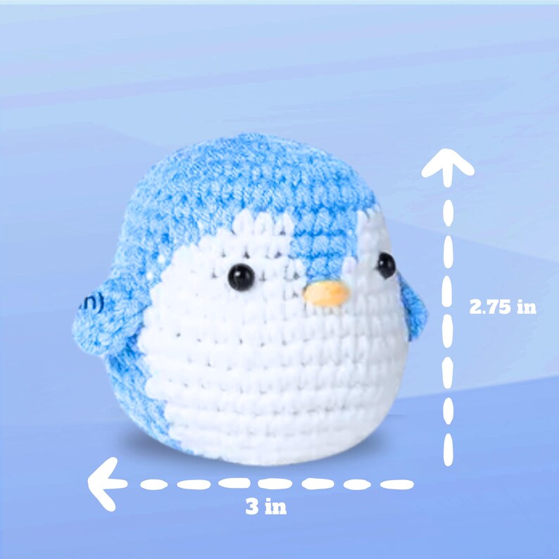 May include: A crocheted penguin toy with a blue body and white face. The penguin is 3 inches wide and 2.75 inches tall.