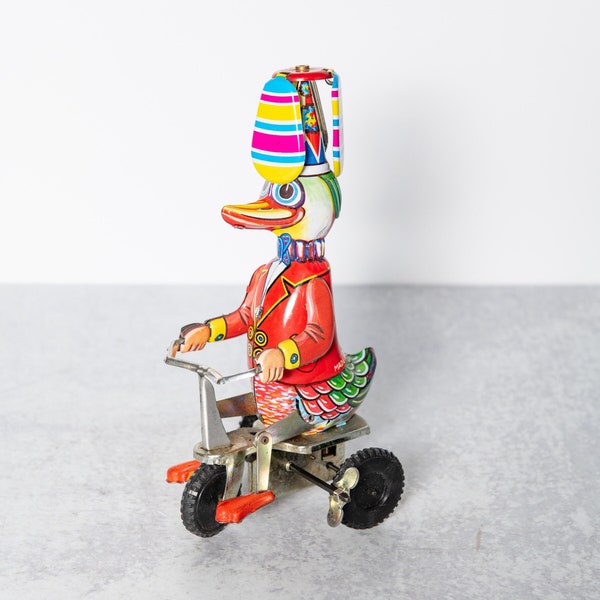 Wind Up Mechanical Tin Litho Circus Duck on Tricycle with Propeller Spinner China Made