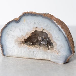 Polished Partial Geode with Smoky Crystal and Pyrite Accented Interior and Silver Mining Cart Trinket Inside