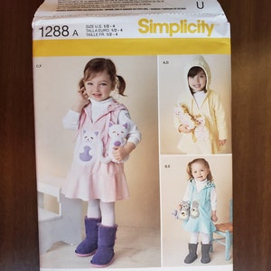May include: Simplicity sewing pattern 1288 A for making children's clothing. The pattern includes three different designs for a hooded sweater, a vest, and a dress. The pattern is designed for sizes 1/2-4.