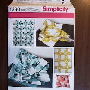 May include: Simplicity sewing pattern number 1390 os for a quilt. The pattern includes instructions for making a quilt, pillow, and throw. The pattern is designed and printed in the USA.
