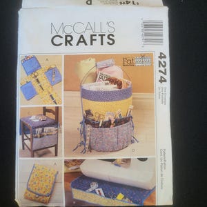 May include: McCall's Crafts sewing pattern envelope. The envelope features images of sewing accessories organizers, including a basket, chair organizer, and a sewing machine cover. The pattern number is 4274.