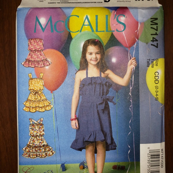 New, uncut sewing pattern, Children’s/Girls’ Dresses and Belt. McCall's pattern M7147, Size CDD (2-3-4-5), halter neckline, ruffles, belt