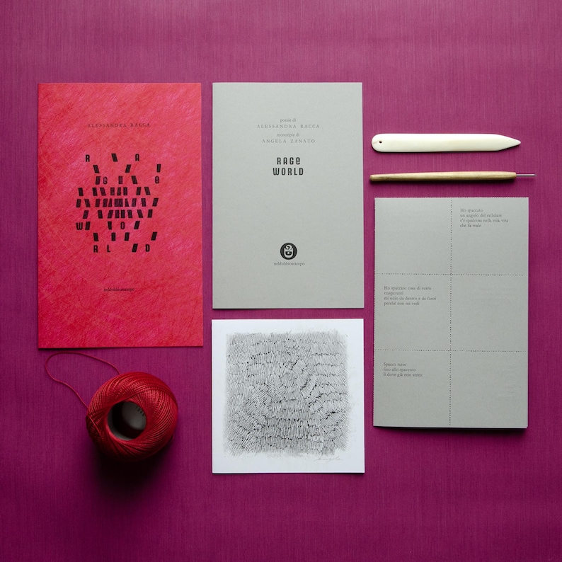 May include: A set of four items, including a red booklet with the text "Rage World" in black, a gray booklet with the text "Rage World" in black, a gray card with a black and white illustration, and a red ball of yarn.