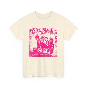 May include: Cream-colored t-shirt featuring a pink graphic of a band with the text "EXTERMINKS" and "GAI". The design includes the text "PARTY ep 001" and "KILLER". The image has a distressed, vintage aesthetic.
