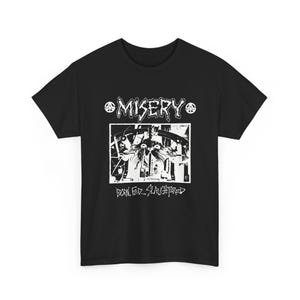 May include: Black t-shirt with a white graphic design. The design includes the word "MISERY" above a rectangular image with an abstract illustration. Below the image, the text reads "BORN. FED... SLAUGHTERED". Peace symbols flank the word "MISERY".