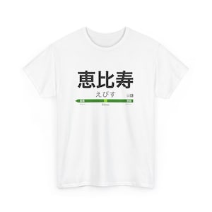 May include: White t-shirt with a black graphic of a Japanese train station sign that reads "Ebisu" in Japanese and English.