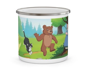 May include: White enamel mug featuring a colorful cartoon scene with a brown bear, a black and white cat, and a person in a blue dress. The background includes green grass, trees, and a forest.