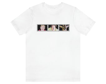 May include: White t-shirt with a black and white image of three faces. The faces are of a man, a woman, and a deer. The faces are all in a state of shock or surprise.