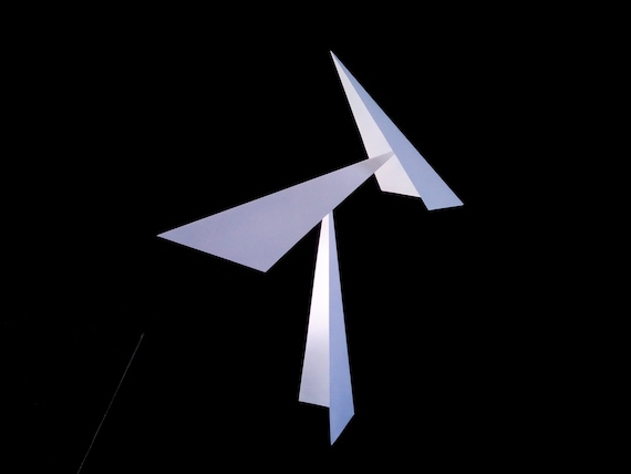 Hand-folded steel mobile that balances and sways like a Calder sculpture — but made by an actual metalsmith for your desk.
