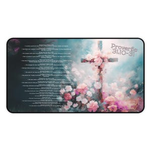 May include: A rectangular mousepad featuring a cross adorned with pink and white flowers against a soft blue and green background. The text "Proverbs 31:10-31" is visible in the upper right corner, with additional text on the left side.
