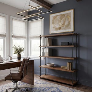 May include: A five-tier industrial bookshelf featuring dark metal pipe framing and thick wooden shelves. The unit stands against a dark grey wall, holding various office supplies, books, and a small bowl, providing open storage for a home office space.