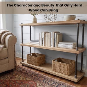 May include: A three-tier shelving unit with light wood shelves and dark metal pipe supports. The top shelf holds a white vase, a geometric wire sculpture, and a bowl. The middle shelf contains books. The bottom shelf features two woven baskets.
