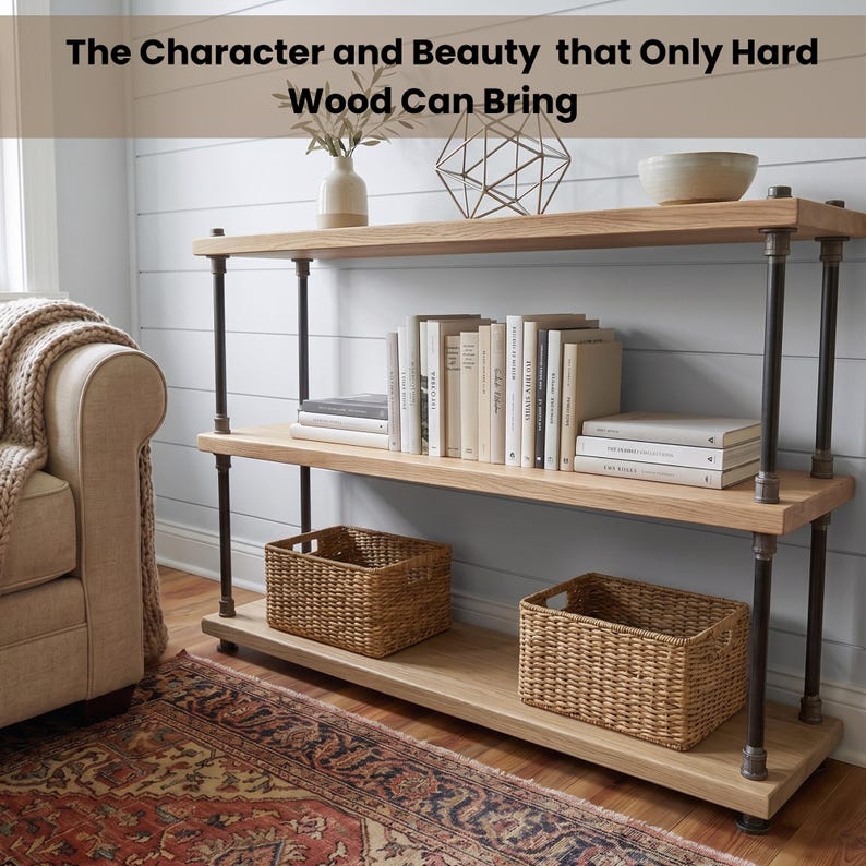 May include: A three-tier shelving unit with light wood shelves and dark metal pipe supports. The top shelf holds a white vase, a geometric wire sculpture, and a bowl. The middle shelf contains books. The bottom shelf features two woven baskets.