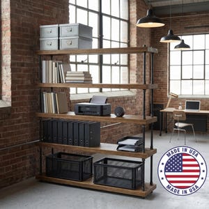May include: A five-tier industrial shelving unit with thick wooden shelves and dark metal pipe supports. The shelves hold grey storage boxes, books, a black printer, black binders, and black wire mesh baskets. A Made in USA circular logo is visible.