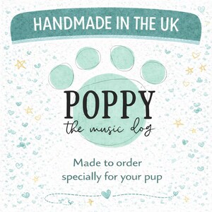 May include: A teal and white graphic with the text "HANDMADE IN THE UK" at the top. The design features a paw print with the name "POPPY the music dog" inside. Below, it reads "Made to order specially for your pup."