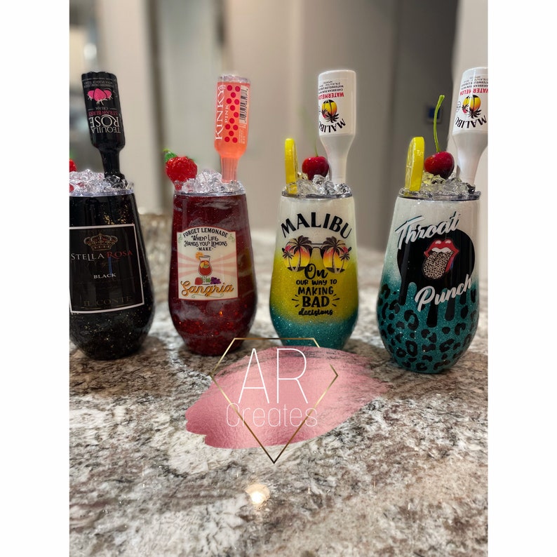 May include: Four different wine tumblers with various designs. The tumblers are decorated with glitter and feature designs such as "Sangria", "Malibu On Our Way To Making Bad Decisions", and "Throat Punch".