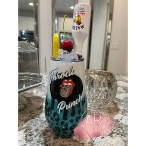May include: A teal and black tumbler with a leopard print design. The tumbler has a white lid and a black and white graphic of a tongue with the words "Throat Punch" on it. A clear bottle with a white label that says "Malibu" is in the background.