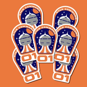 May include: Six blue and white Star Command stickers with a spaceship design and the text "010101".
