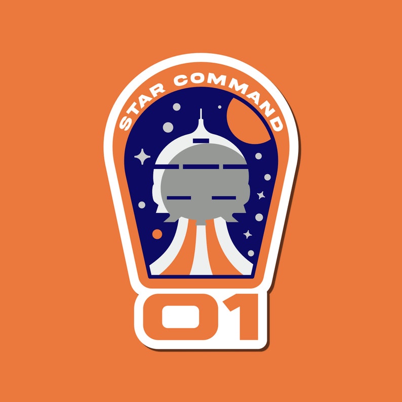 May include: A blue and white sticker with the text "STAR COMMAND 01" and a spaceship illustration. The spaceship is gray and white with a blue background. The sticker has a white border.