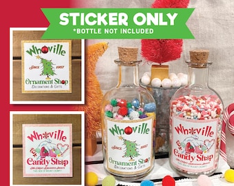 May include: Two sticker labels for a Whoville themed Christmas ornament shop and candy shop. The labels feature a green Christmas tree, a pink house, and the text "Whoville" and "Since 1957".