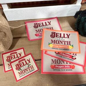 May include: Four red and orange paper cards with the text "Jelly of the Month" and different jelly flavors: Red, Orange Marmalade, Cherry, and Pepper Jelly. Each card has the text "Official Club Member".