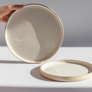 Minimal ceramic plates with a rim, speckled plates with edge, unglazed beige clay and white glossy glaze stoneware dinnerware, ecru dishes