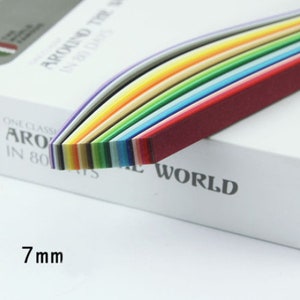 May include: A pack of 7 mm wide quilling paper strips in a rainbow of colors. The paper is arranged in a curved shape, with the red strip on top and the purple strip on the bottom.
