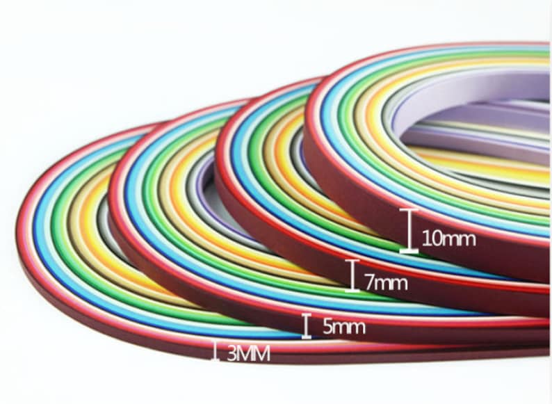 May include: Assortment of colorful paper strips in various widths, including 3mm, 5mm, 7mm, and 10mm. The strips are arranged in a rainbow pattern.