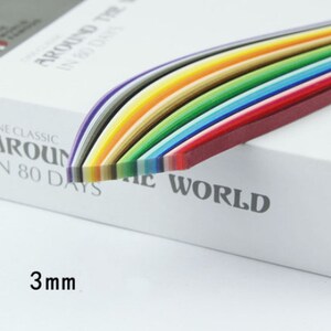 May include: A pack of 3mm wide paper quilling strips in a rainbow of colors. The pack is labeled "Around the World in 80 Days, The Classic".