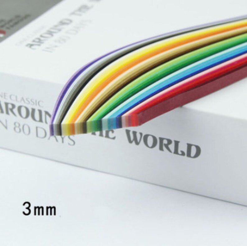 May include: A pack of 3mm wide paper quilling strips in a rainbow of colors. The pack is labeled "Around the World in 80 Days, The Classic".