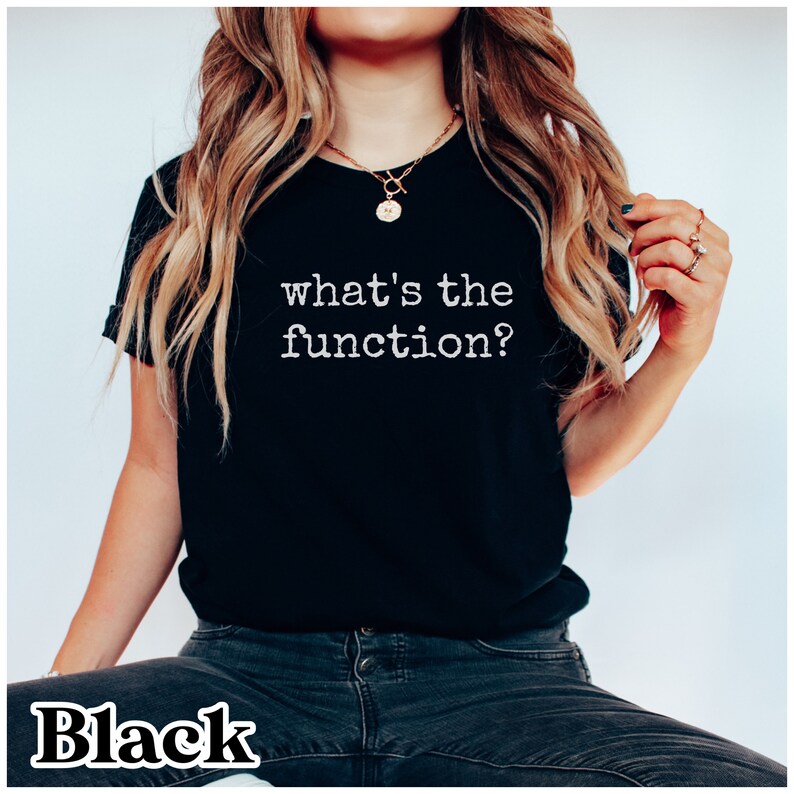 May include: A black t-shirt with the text "what's the function?" printed in white.