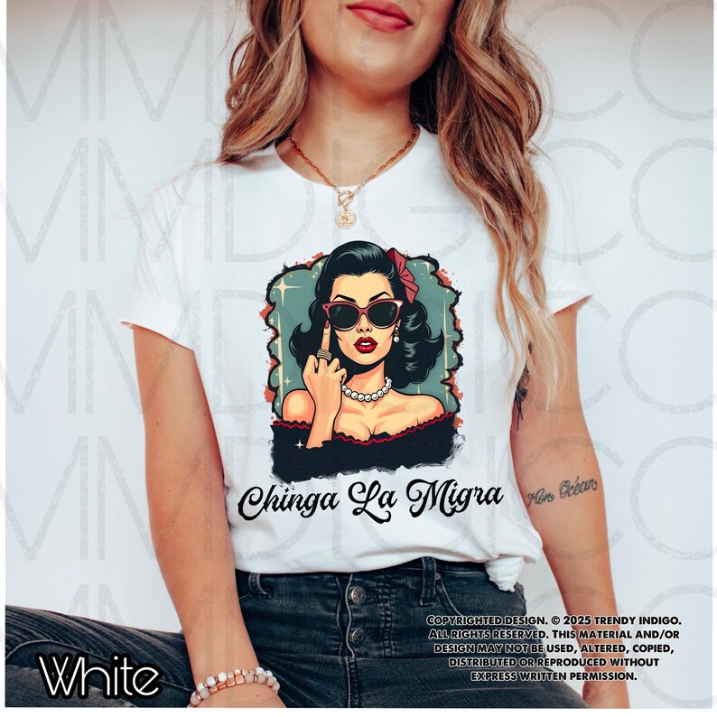 May include: White t-shirt with a graphic of a woman wearing sunglasses and giving the middle finger. The text "Chinga La Migra" is printed below the graphic.