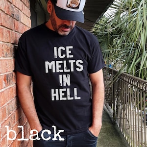 May include: Black t-shirt with the white text "ICE MELTS IN HELL". The word "black" is written in white at the bottom of the image. The person in the image is wearing a black and white trucker hat.