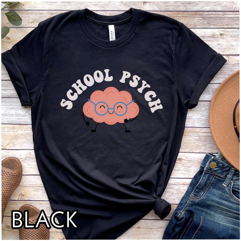 May include: Black t-shirt with a cartoon brain wearing glasses and the text "SCHOOL PSYCH" in a retro font.