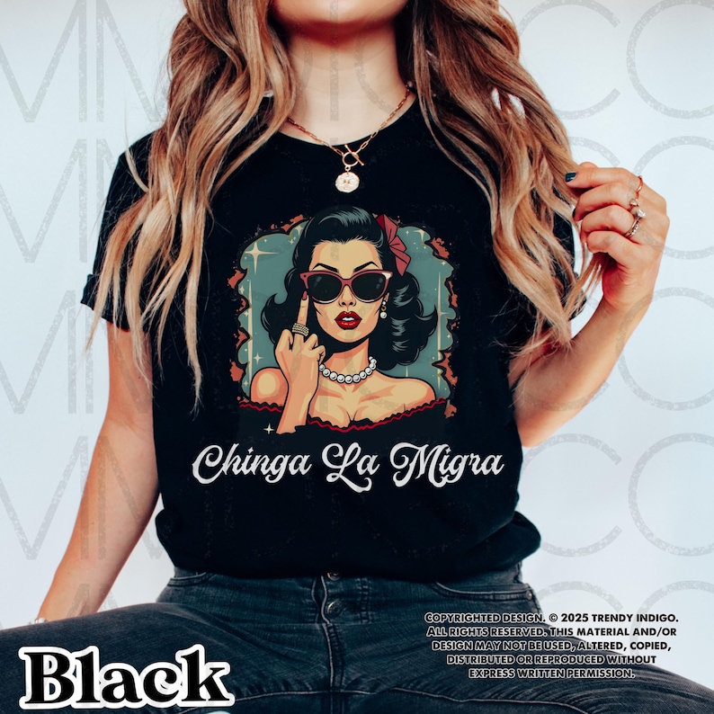 May include: Black t-shirt with a graphic of a woman wearing sunglasses and giving the middle finger. The text "Chinga La Migra" is printed below the graphic. Copyright information is printed at the bottom of the shirt.