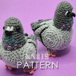 May include: Two crocheted pigeons made with grey yarn, featuring black bead eyes, small black beaks, and pink feet. The neck areas have embroidered accents in teal and purple. The text "complicated KNOTS PATTERN" is overlaid in white.
