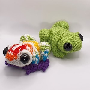 May include: Two crocheted frog plushies. One is green and the other is rainbow colored.