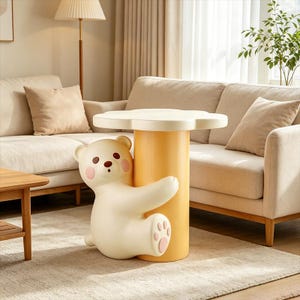 May include: A side table featuring a cream-colored bear figure hugging a cylindrical yellow base. The tabletop is shaped like a flower with rounded petals. The bear has brown eyes, a brown nose, and pink circular cheeks, with pink paw pads on its feet.