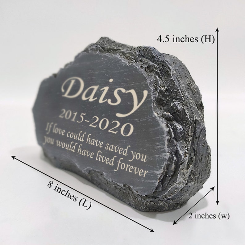May include: A gray stone memorial with the inscription "Daisy 2015-2020 If love could have saved you you would have lived forever". The stone is 4.5 inches high, 8 inches long, and 2 inches wide.