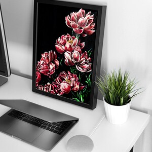 May include: A framed painting of red peonies on a black background. The painting is on a white desk with a laptop, a smart speaker, and a potted plant.