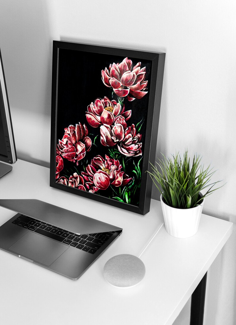 May include: A framed painting of red peonies on a black background. The painting is on a white desk with a laptop, a smart speaker, and a potted plant.