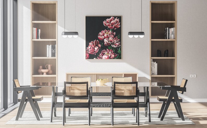 May include: A dining room with a glass table and six black chairs with woven cane seats. The table is set with a bowl of fruit and a floral painting hangs on the wall behind it.