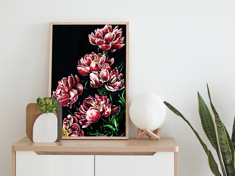 May include: Framed painting of red peonies on a black background. The painting is in a wooden frame and is hanging on a white wall.
