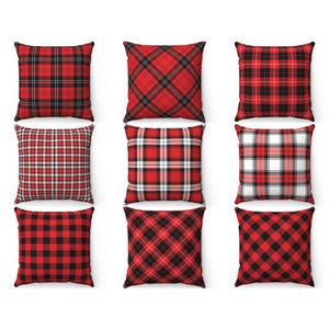May include: Nine red and black plaid throw pillows with different patterns. The pillows are arranged in three rows of three.
