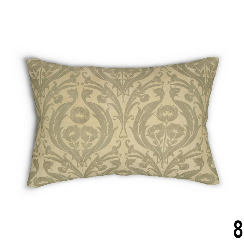 May include: A beige throw pillow with a green floral pattern. The pattern features stylized leaves and flowers.